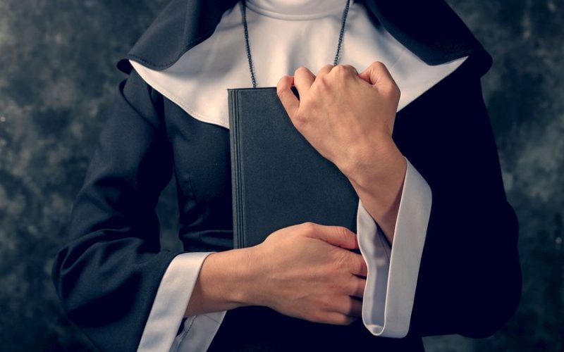 Nun holding bible